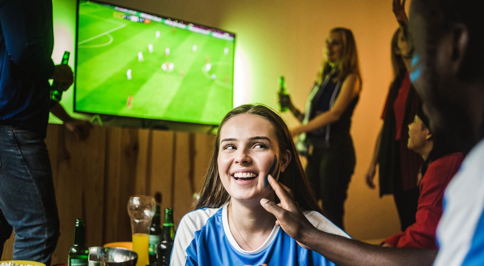 Large Web and Screen A group of friends watching a football game