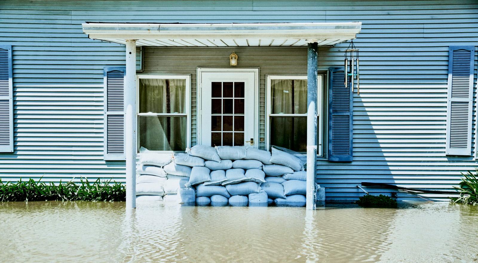 Large Web and Screen A sandbag wall at the entrance of a house on a flooded street