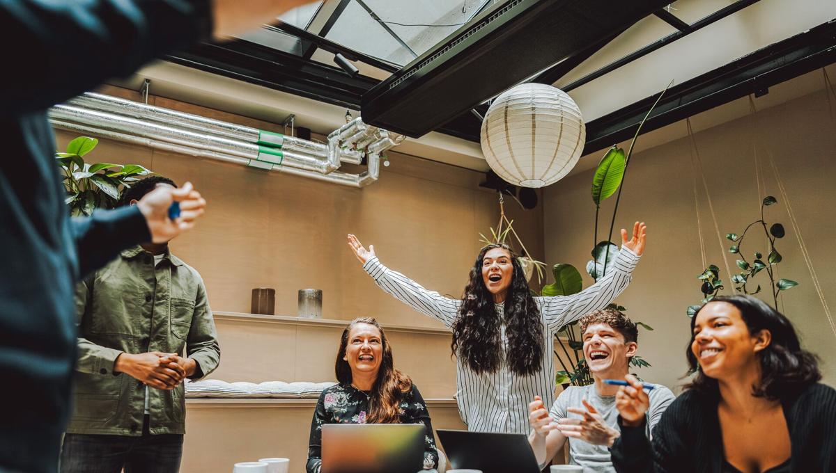 Colleagues celebrate together in office