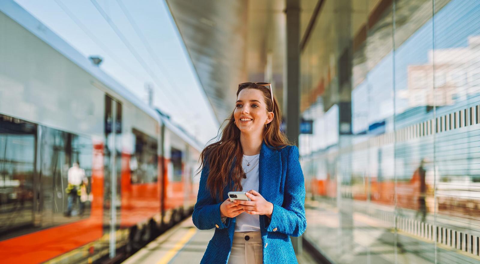 Large Web and Screen Young worker at train station on phone