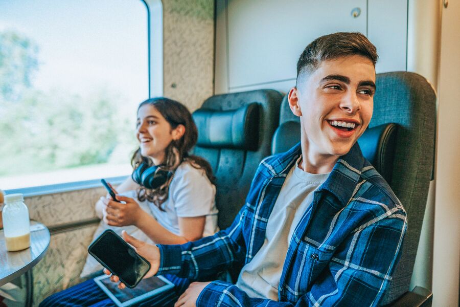 Medium Office 365 and Newsletters Teenage boy on a train with younger sister