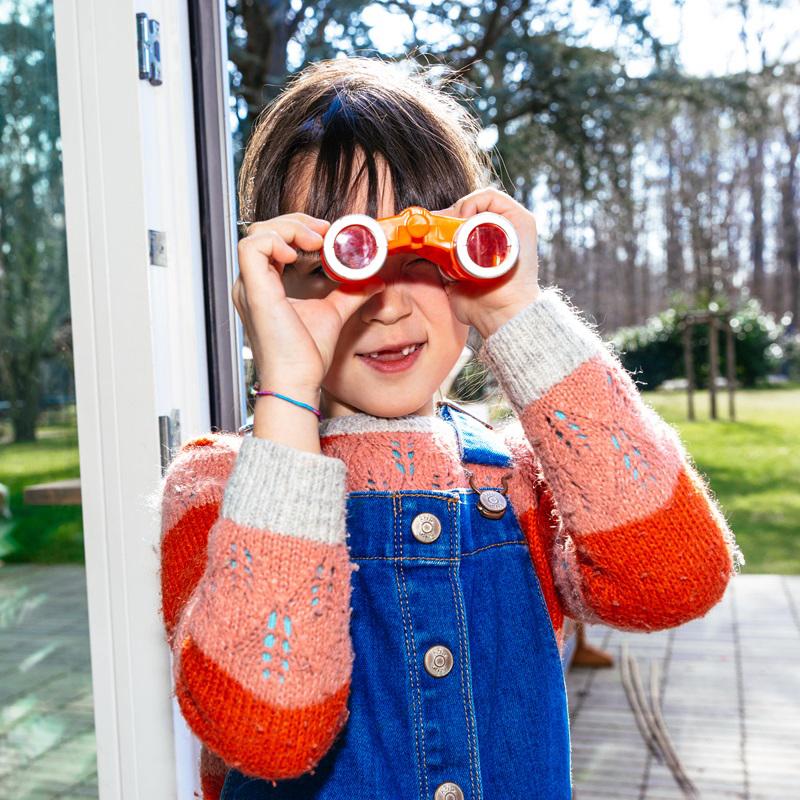 young girl use binocular